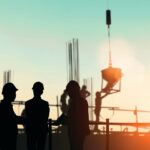 Silhouette engineer standing orders for construction crews to wo