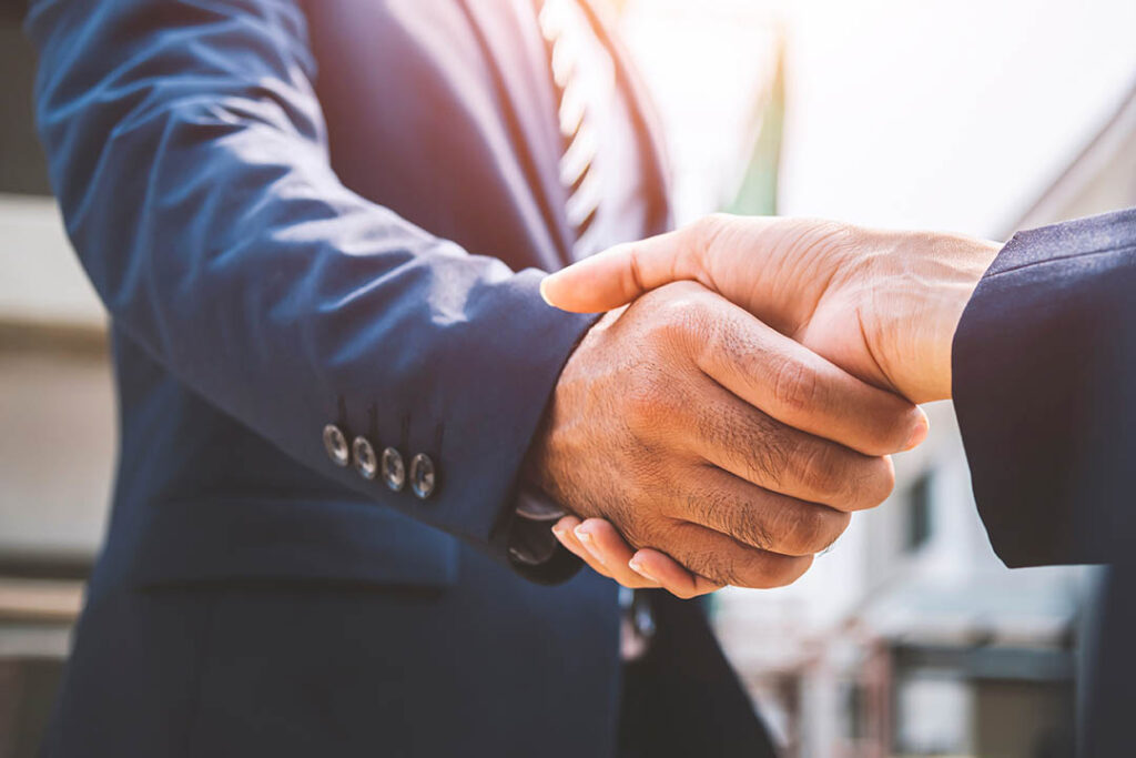 Businessman and businesswoman shaking hands, business deals and